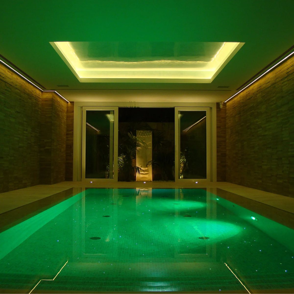 Indoor pool lit with green LED and fibre-optic star lighting