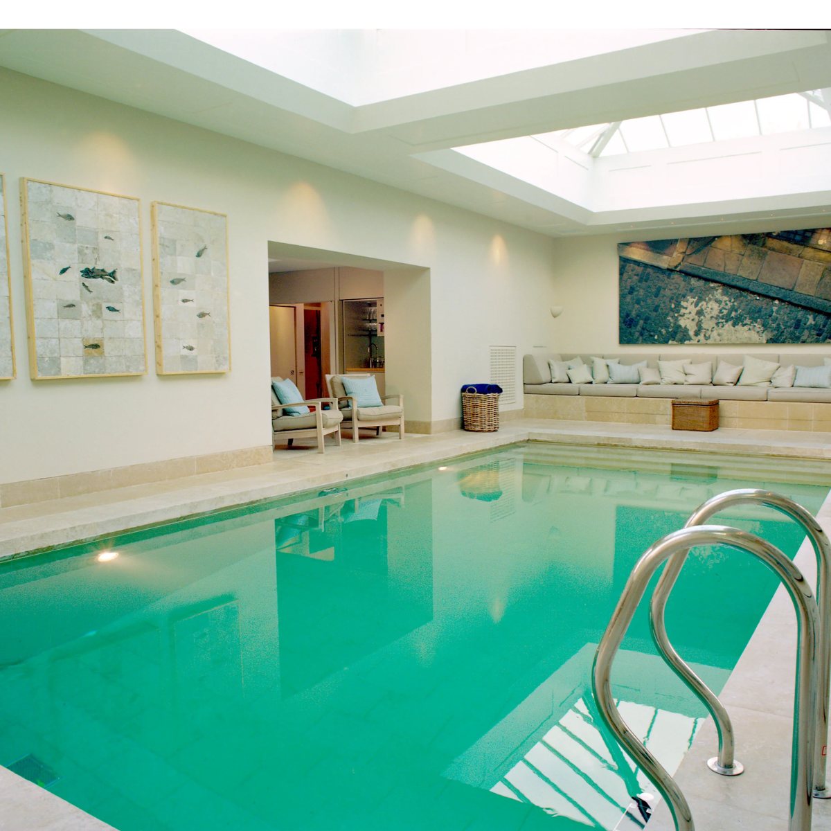 Indoor pool with roof lantern, seating and artwork